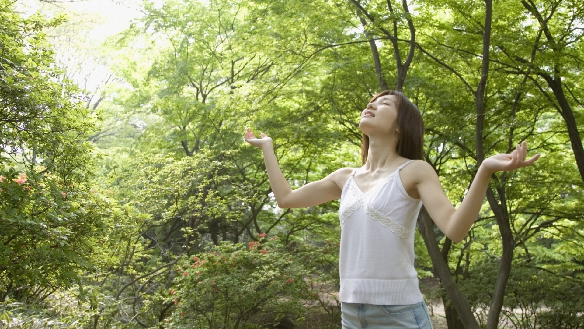 woman enjoying the vitality that the surrounding forest is providing