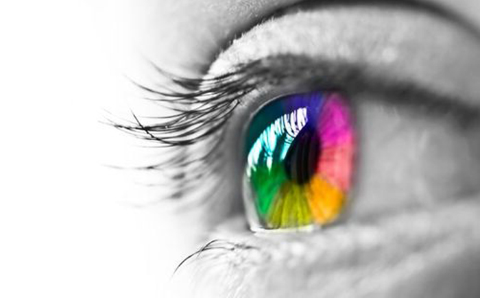 Polychromatic colored eye pupil with seemingly enhanced colours from juxtaposition with black and white surrounding eyelid and lashes